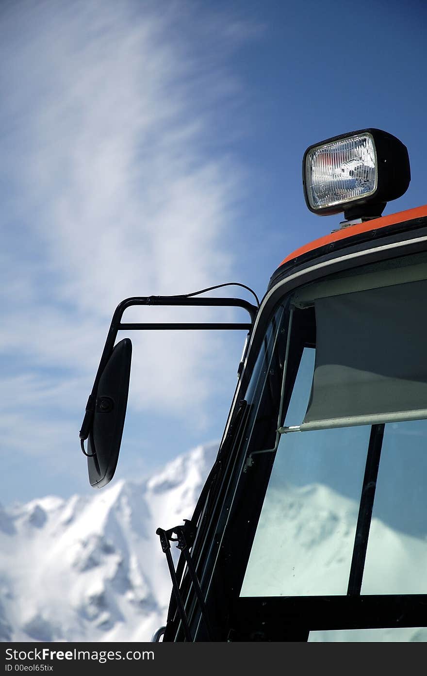 The cabin of grooming machine on a background of mountains. Elbrus area, Russia