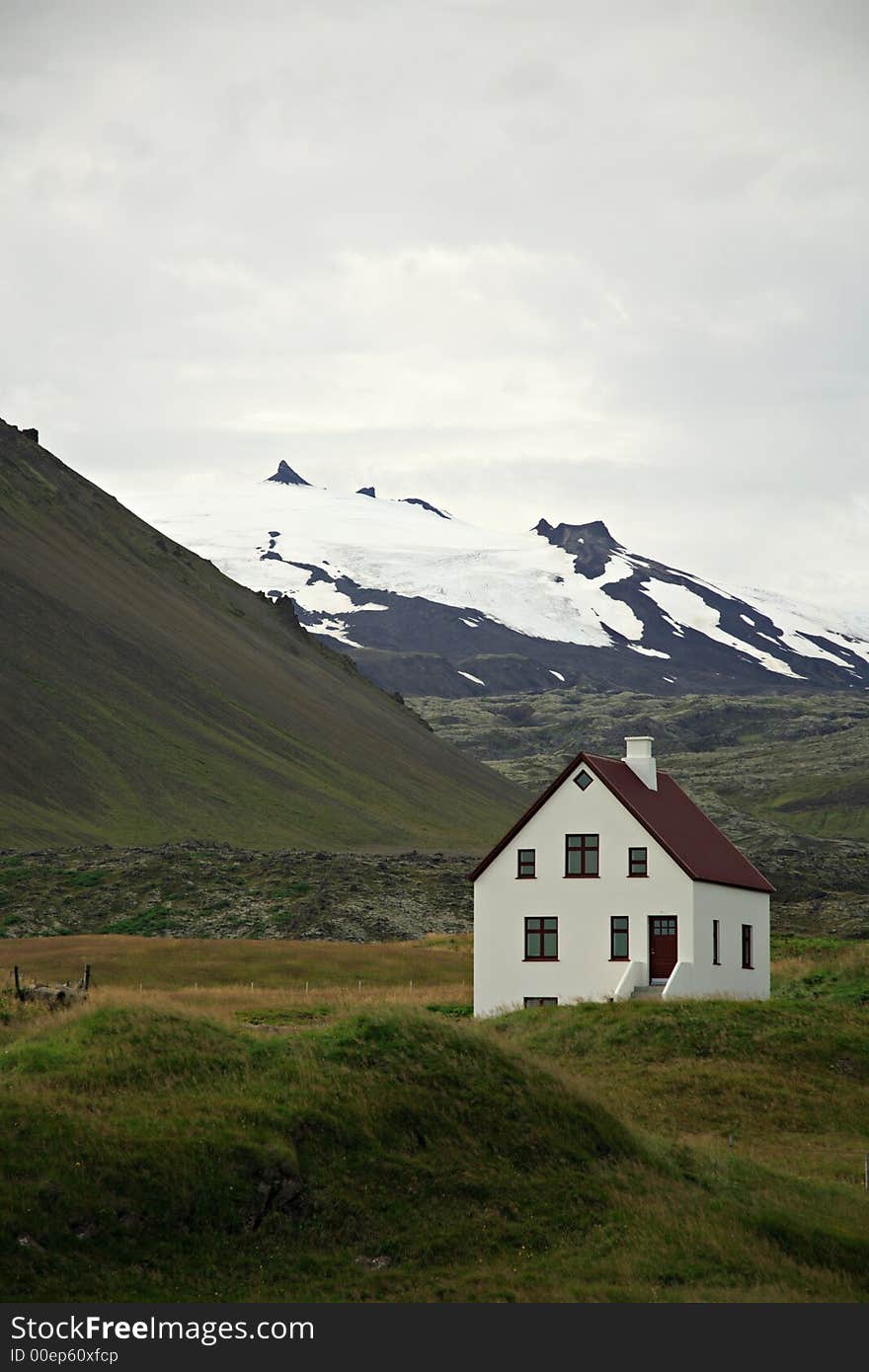 White house with the snow topped Snaefellsjokull mountain in the background Iceland. White house with the snow topped Snaefellsjokull mountain in the background Iceland