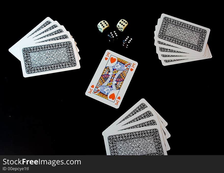 Playing cards and dices on black background