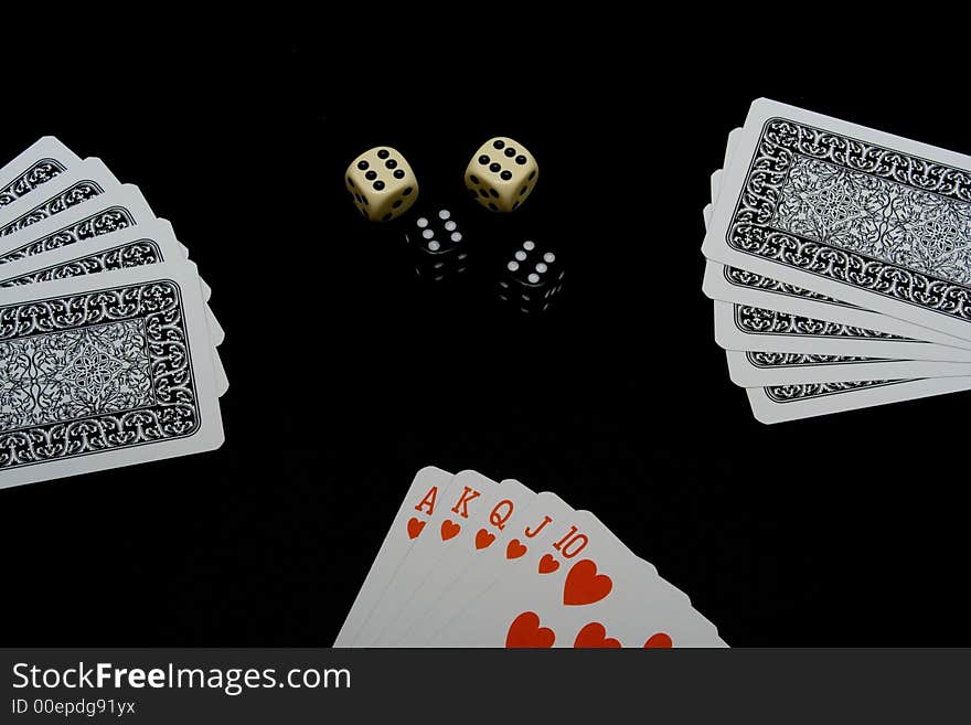 Playing cards and dices on black background