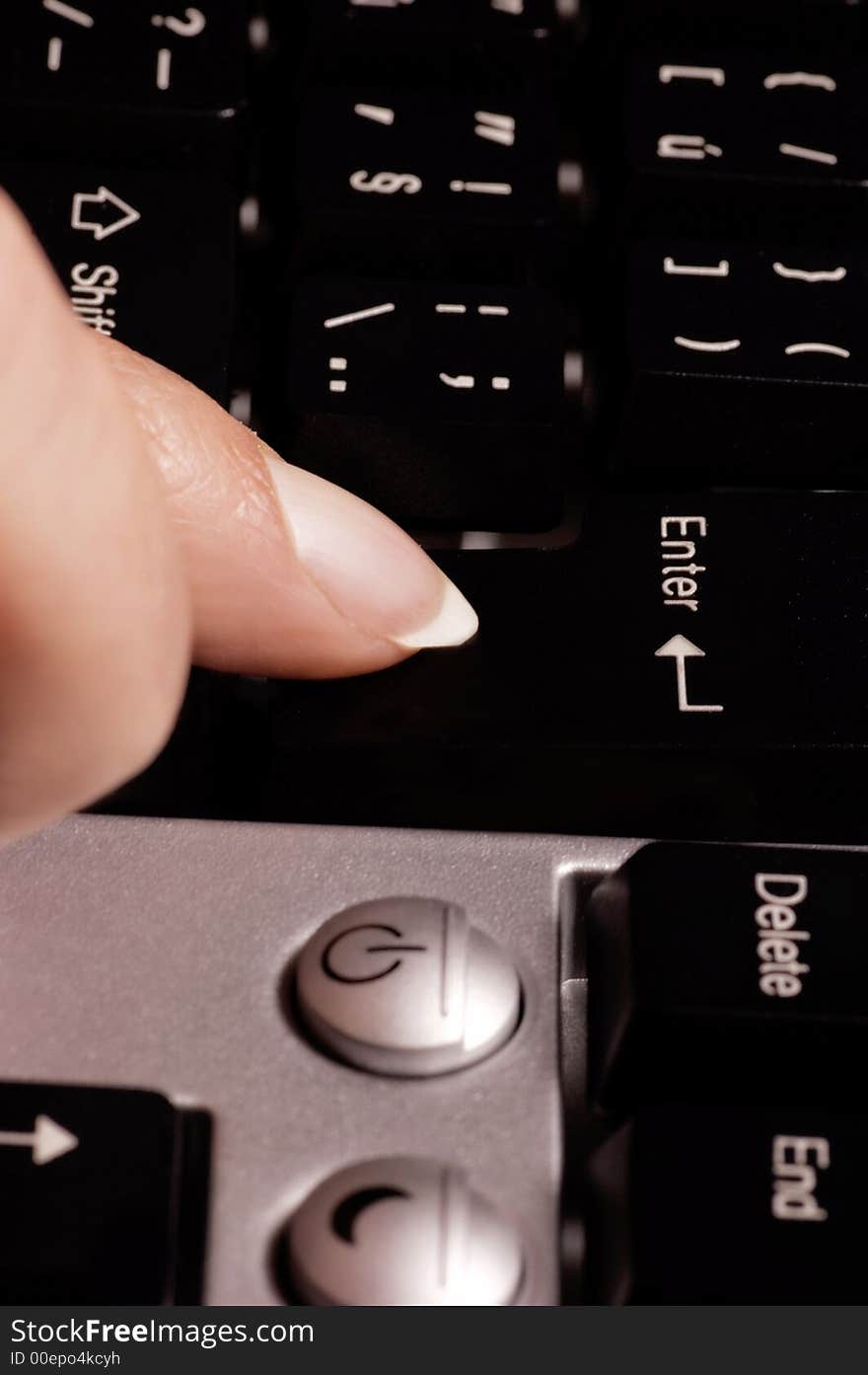 Female finger pushing the button enter on computer keyboard. Female finger pushing the button enter on computer keyboard