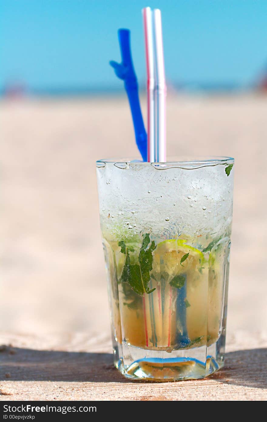 Mojito cocktail on a beach-rum, sugar, mint, soda, ice,