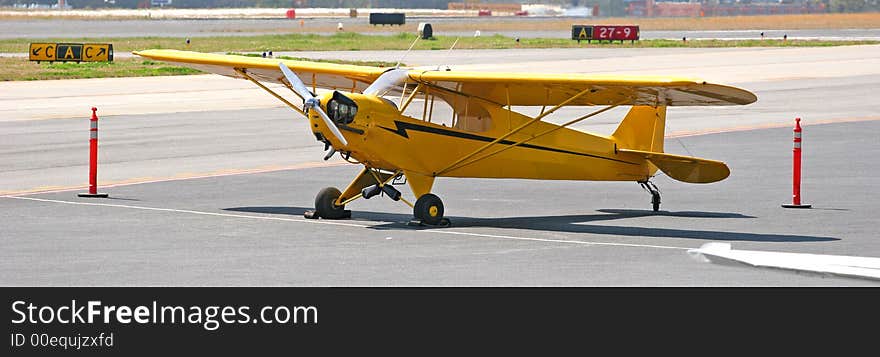 A classic old yellow plane used for flying lessons