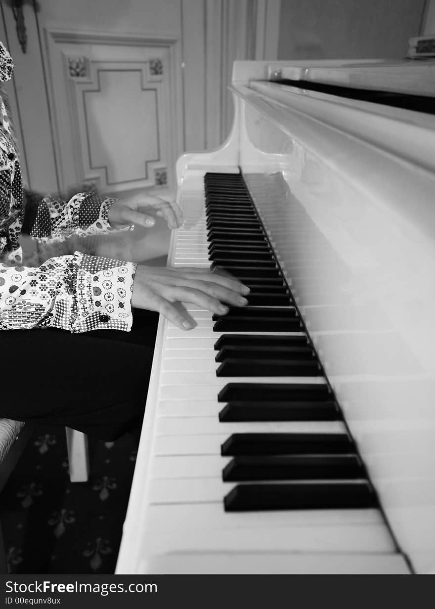 The image of the piano and child's hands. The image of the piano and child's hands