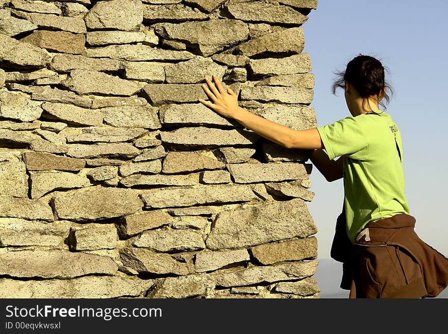 Girl Climbing on an ancient wall