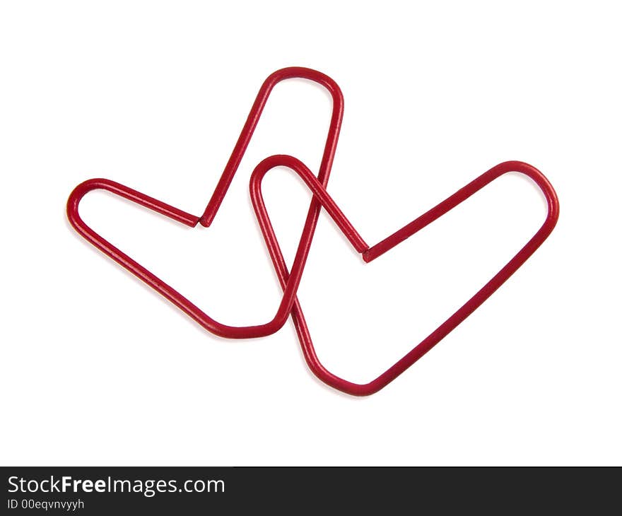 Office love, two paper clips in heart form, isolated on white background