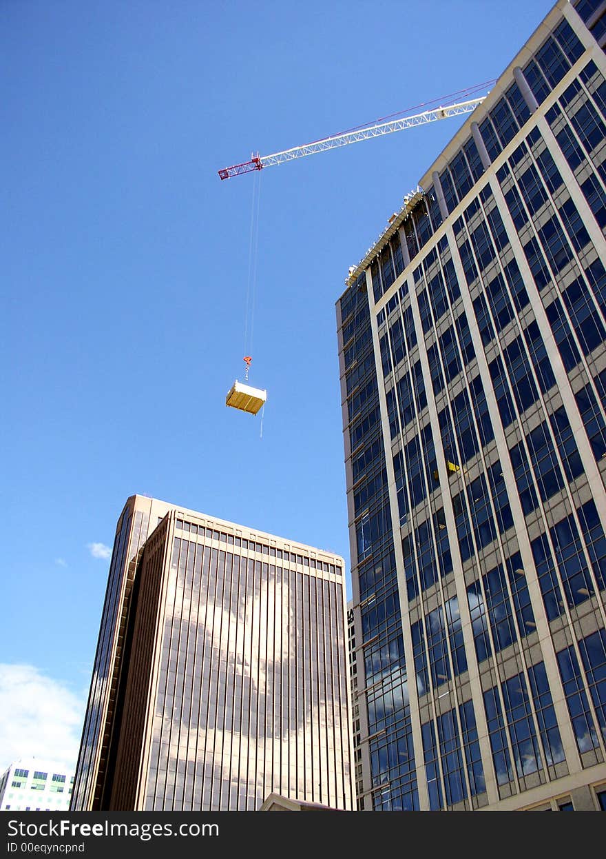 Crane lifting large boxes for construction purposes. Crane lifting large boxes for construction purposes