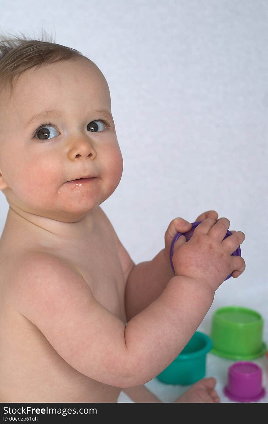 Image of adorable baby playing with stacking cups. Image of adorable baby playing with stacking cups