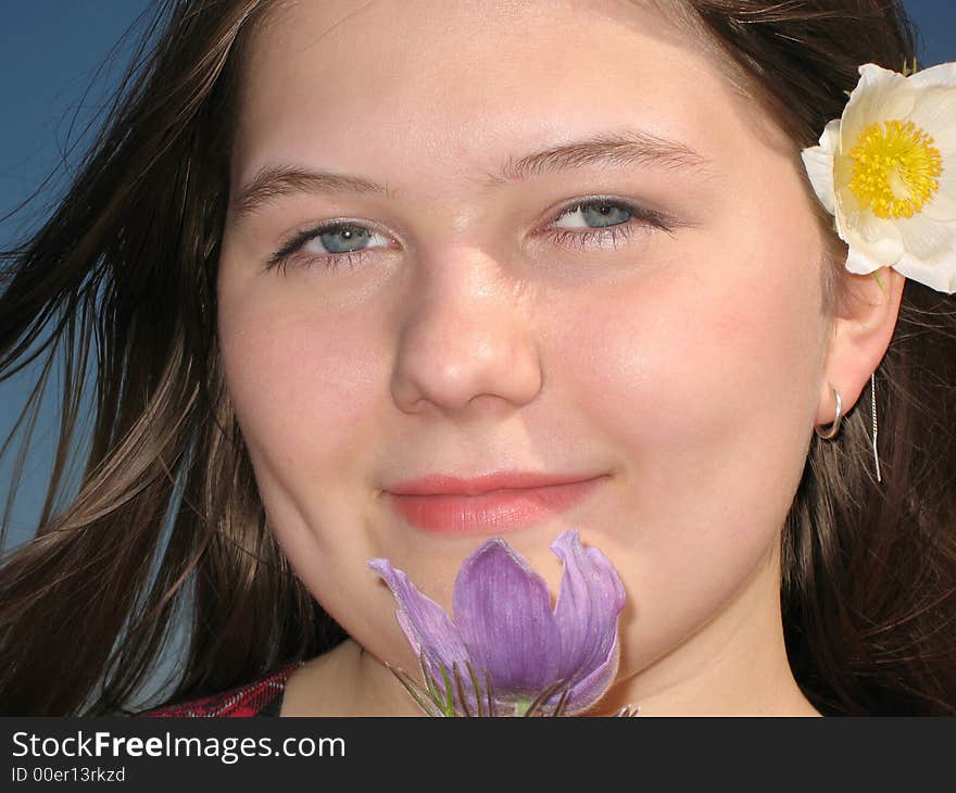 Pretty young girl with the flower in the hair