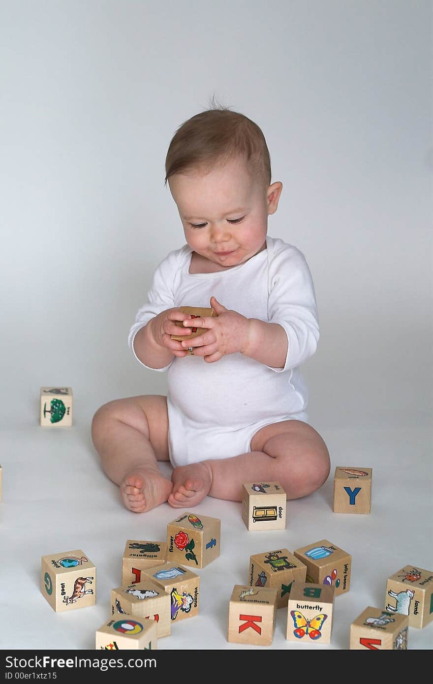 Image of cute baby playing with alphabet blocks. Image of cute baby playing with alphabet blocks