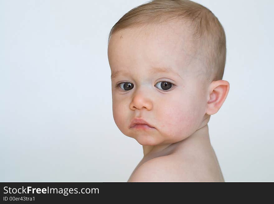 Image of beautiful 11 month old baby boy  sitting in front of a white background. Image of beautiful 11 month old baby boy  sitting in front of a white background