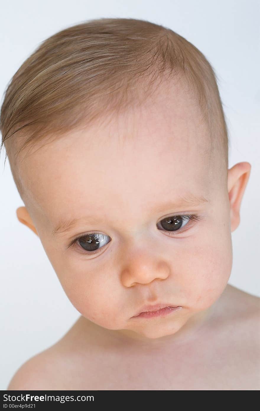 Image of beautiful 11 month old baby boy  sitting in front of a white background. Image of beautiful 11 month old baby boy  sitting in front of a white background