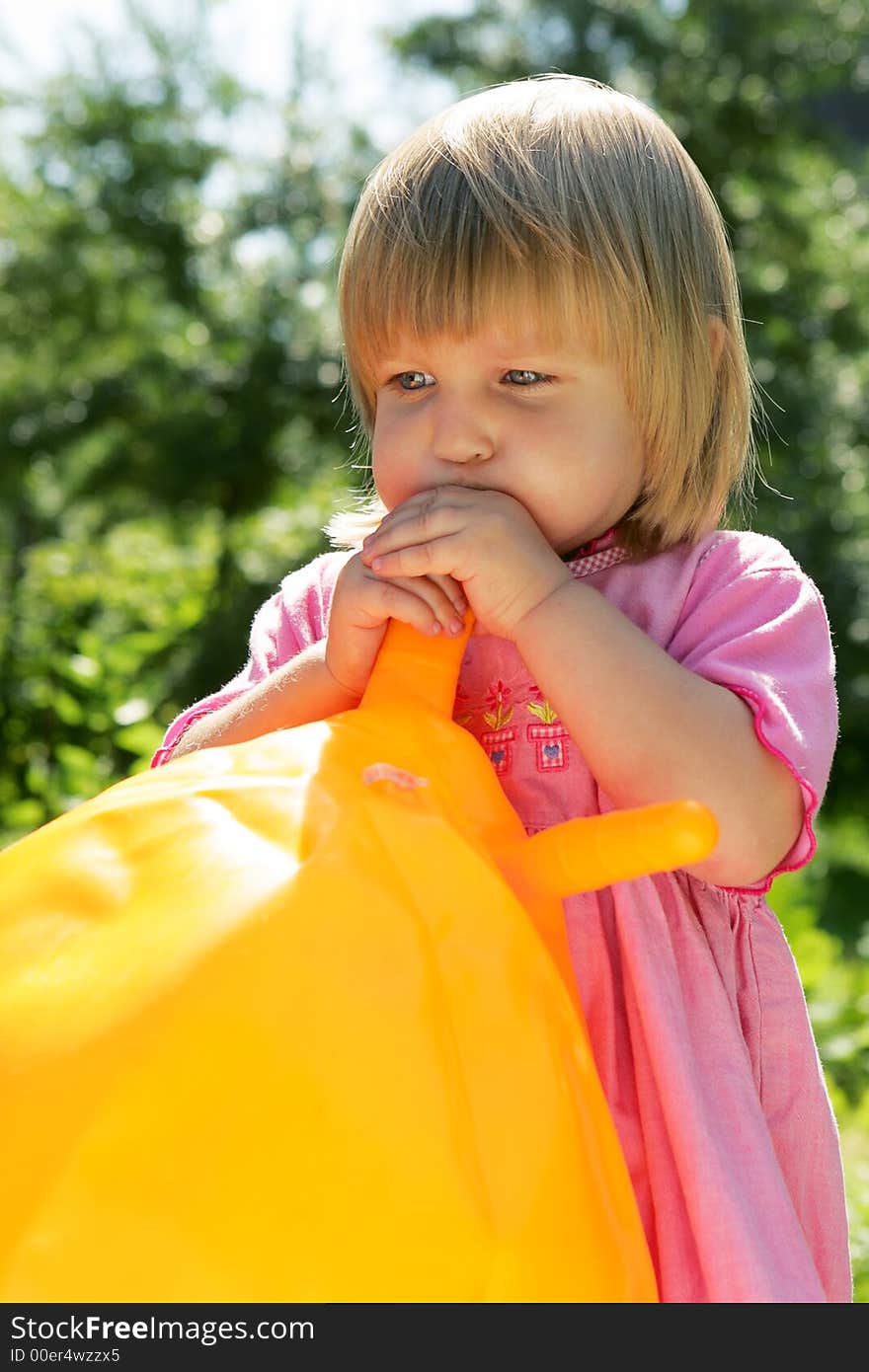 The girl inflates a ball. The girl inflates a ball