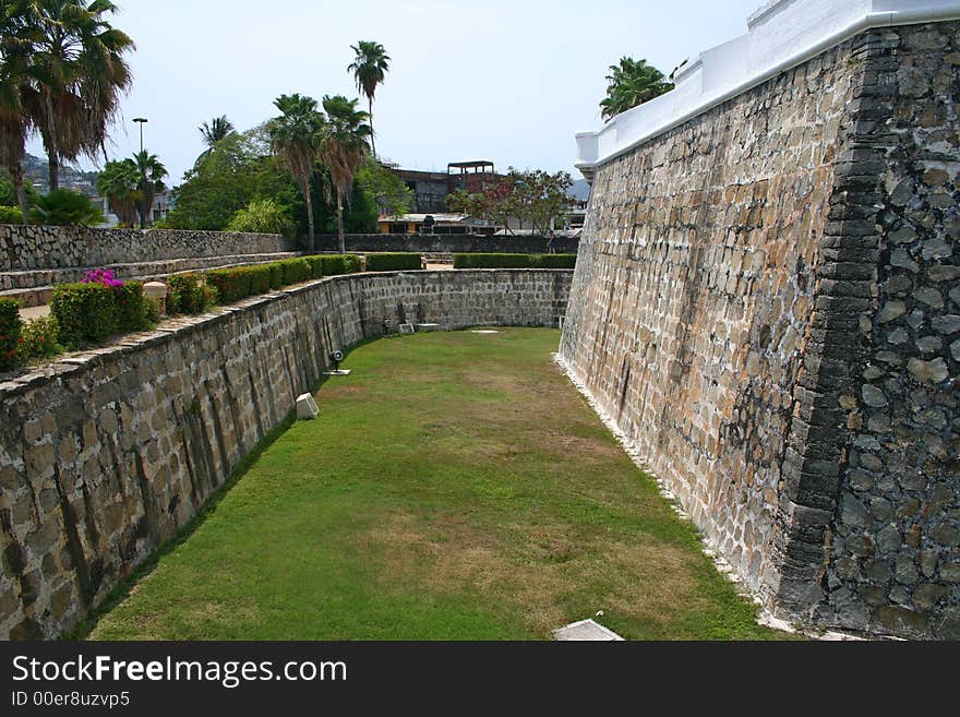 Tall stone wall and defence ditch. Tall stone wall and defence ditch