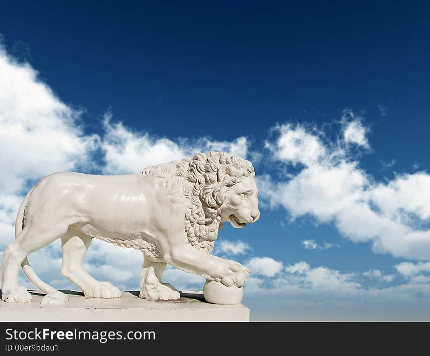 Sculpture of a white lion on a background of the blue sky. Sculpture of a white lion on a background of the blue sky