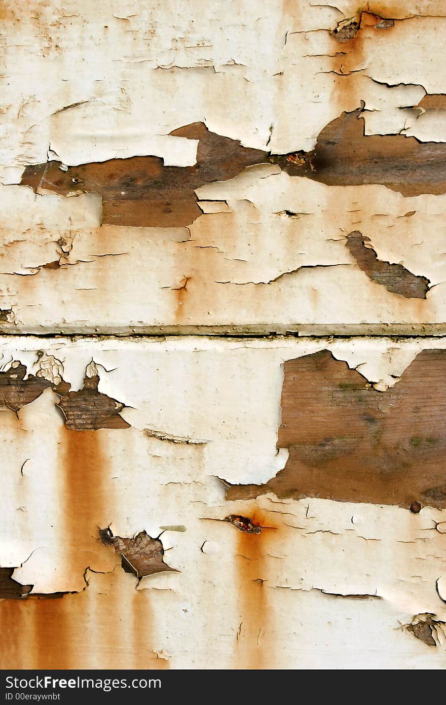 Old white peeling paint on oak, with rust colored tinges.