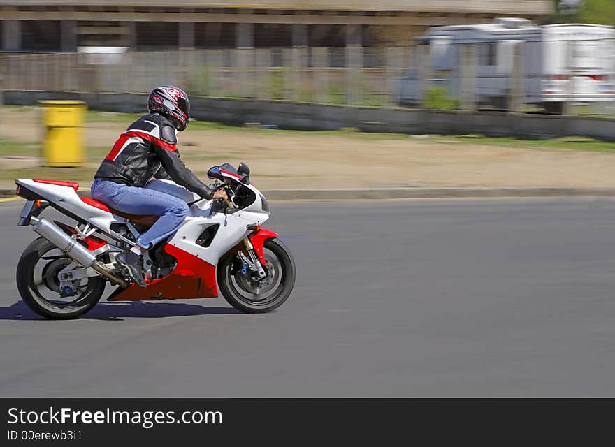 Panning image of a biker on a road. Panning image of a biker on a road.