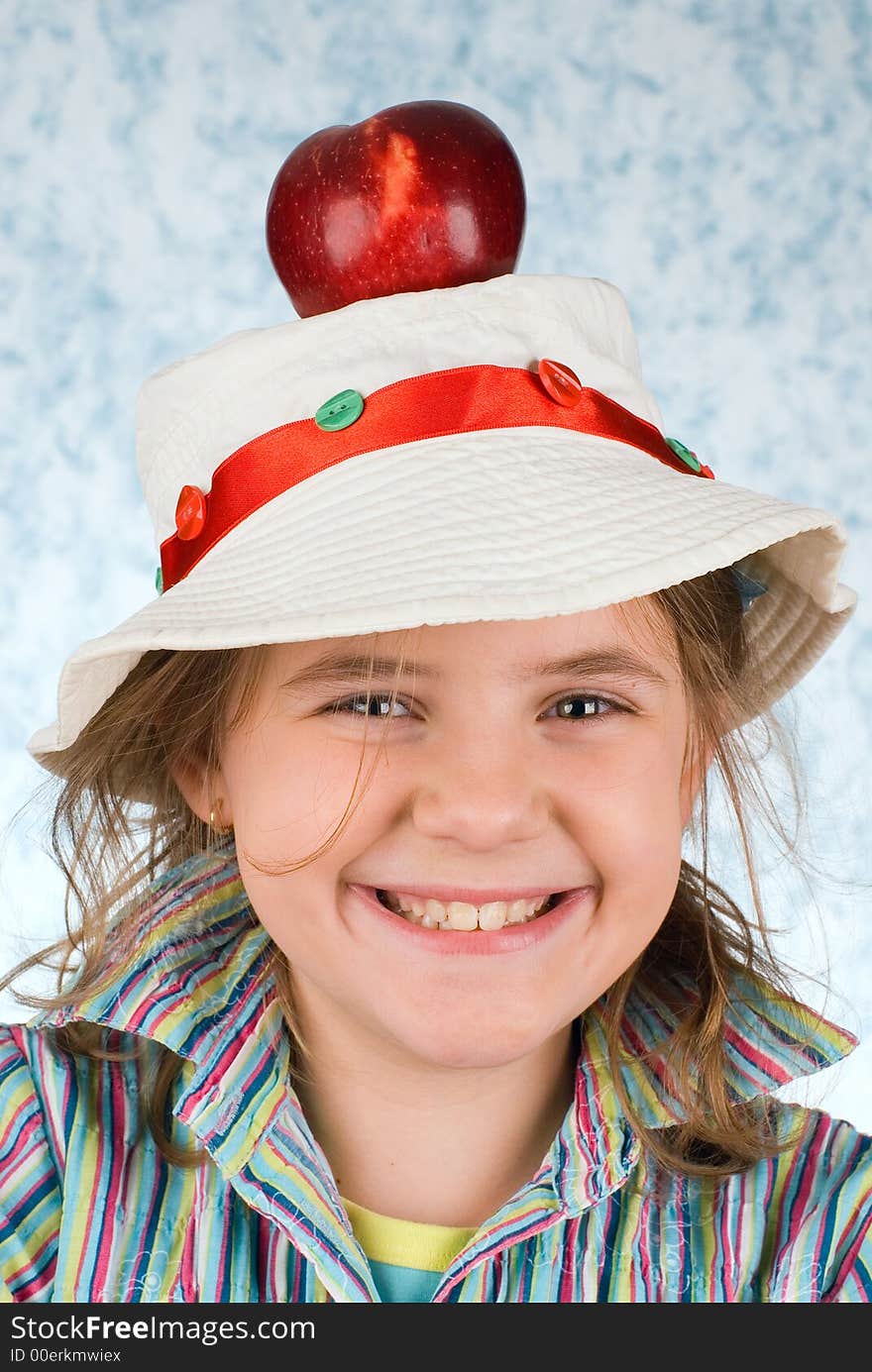 The girl in a dress with an apple on a blue background. The girl in a dress with an apple on a blue background