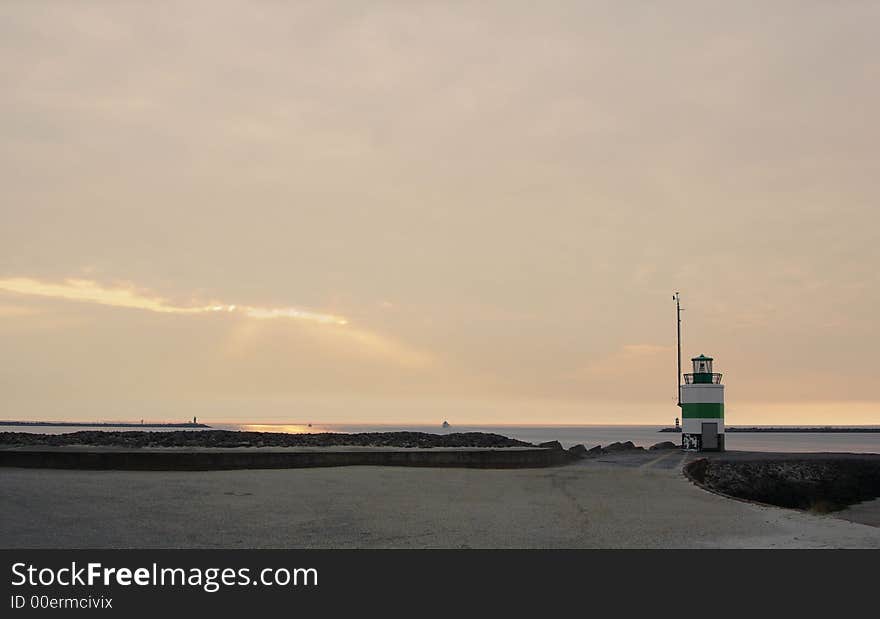 A lightbeacon during sunset at beach. A lightbeacon during sunset at beach