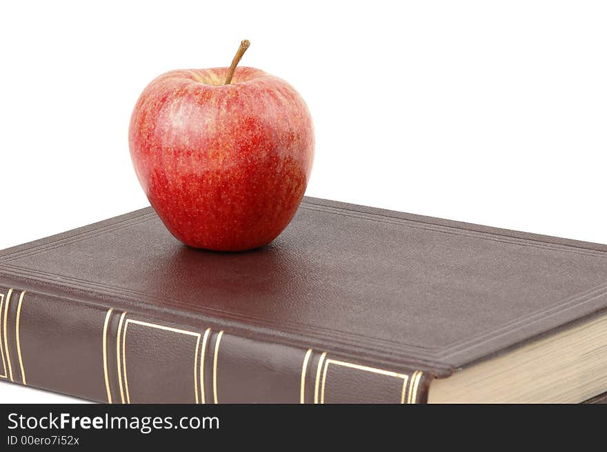 Red apple sitting on a book. Red apple sitting on a book.