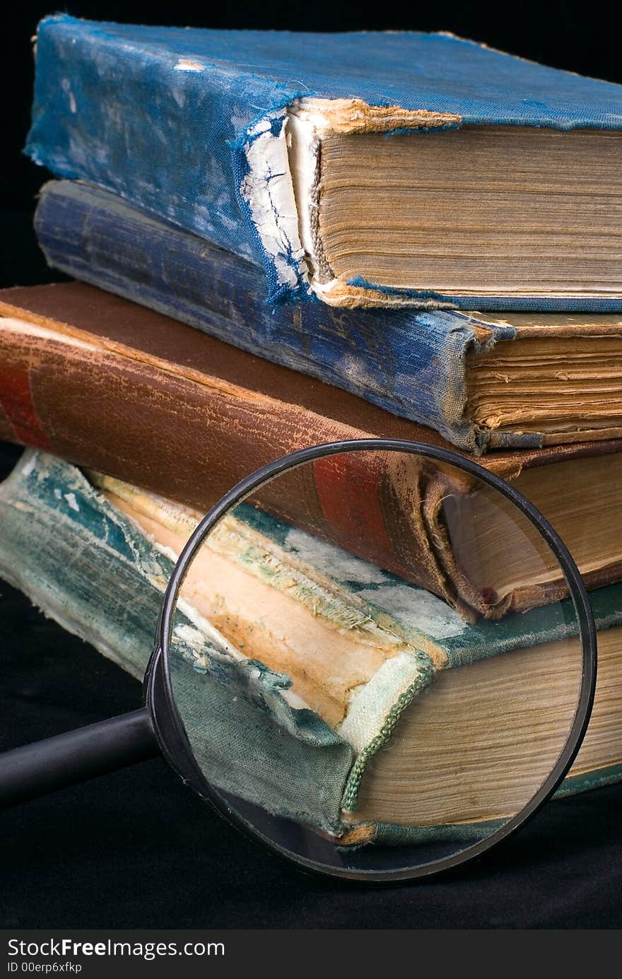 Old books and magnifier