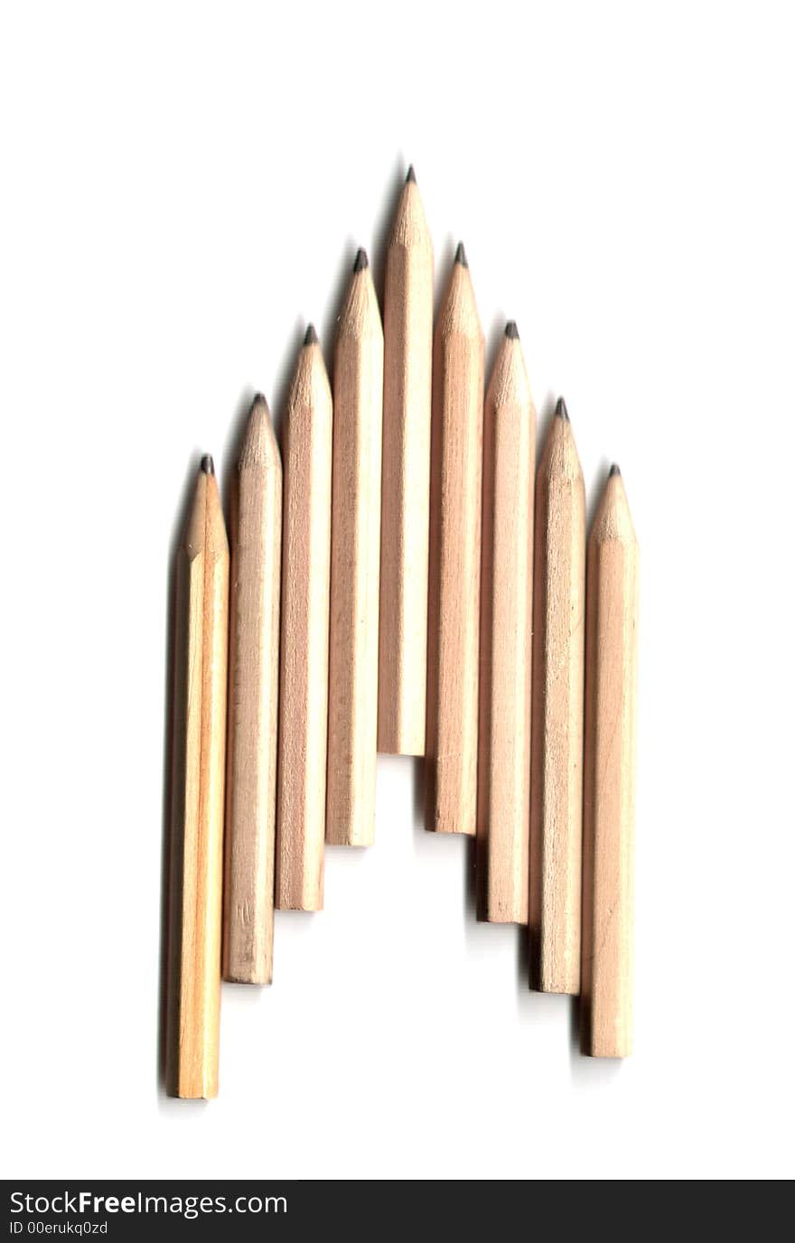 Nine pencils in an arrow style row on an isolated white background. Nine pencils in an arrow style row on an isolated white background