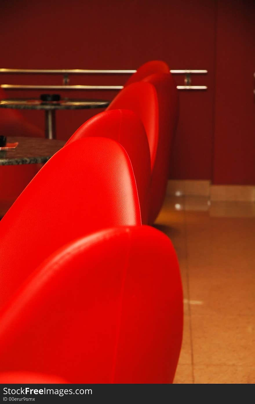 Interior of modern restaurant. Red leather and luxury chairs.