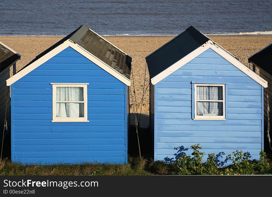 Two blue painted Beach Huts