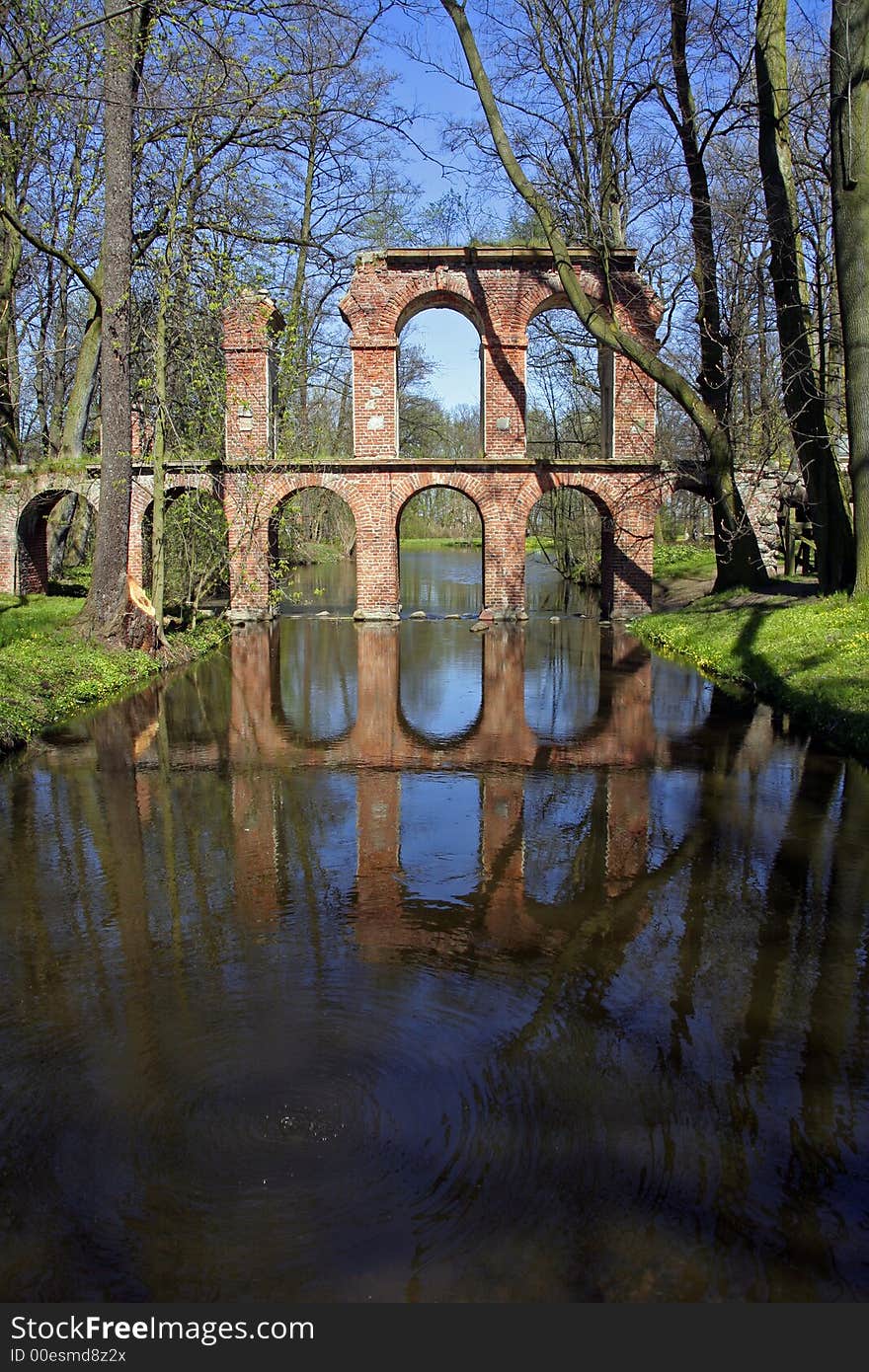 Antique roman aqueduct reflecting in a pool of water. Antique roman aqueduct reflecting in a pool of water