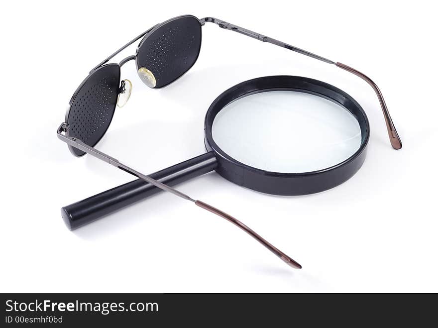 Glasses and magnifier isolated over white background. Glasses and magnifier isolated over white background