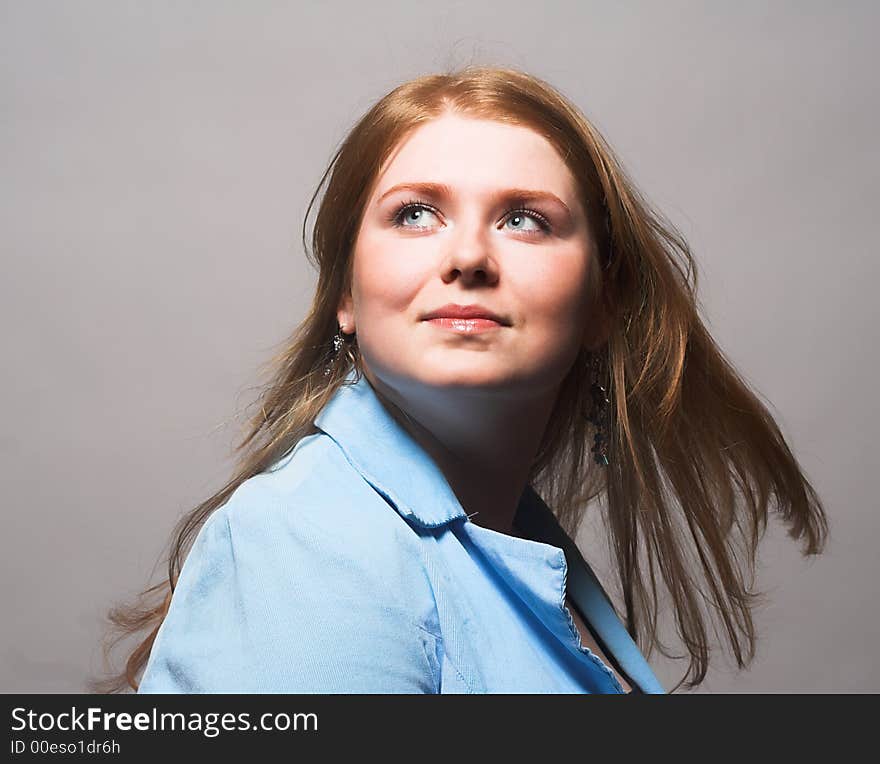 Portrait of Fresh and Beautiful red-hair woman wearing blue shirt. Portrait of Fresh and Beautiful red-hair woman wearing blue shirt