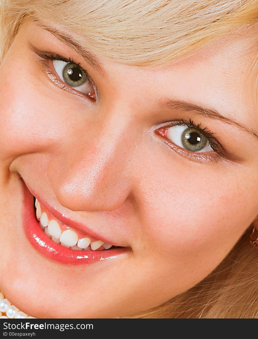 Beautiful young woman face. Close up. Over white background