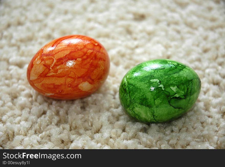 Colourful Easter eggs lying on a cream carpet