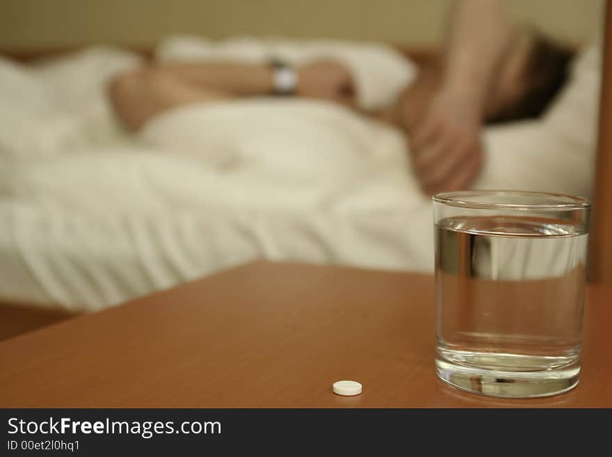 Tablet and glass with water on a table