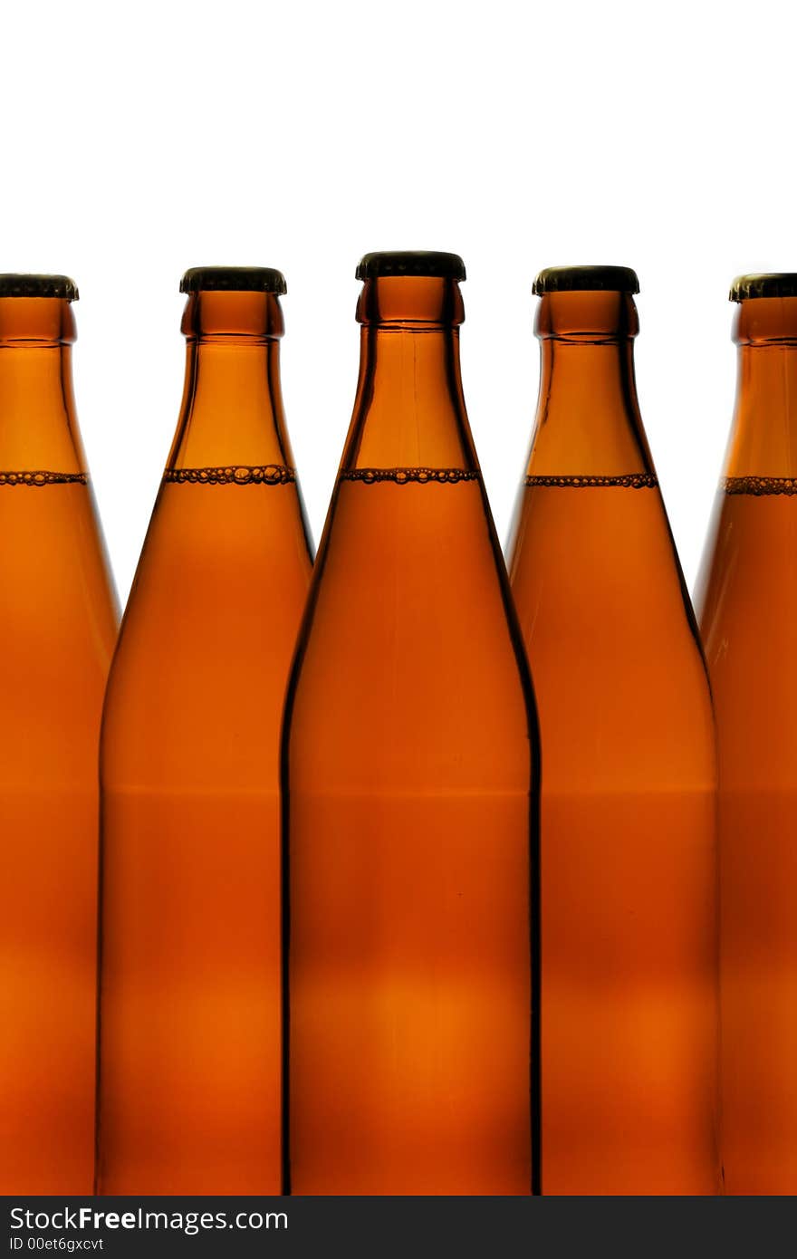 Beer bottles close-up isolated over a white background