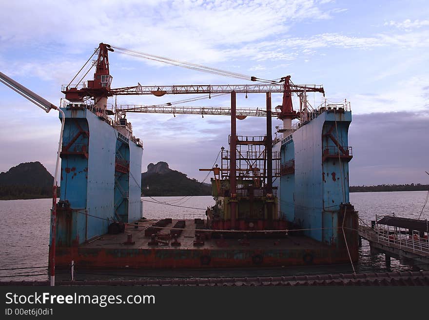 A floating dry dock carrying a barge. A floating dry dock carrying a barge