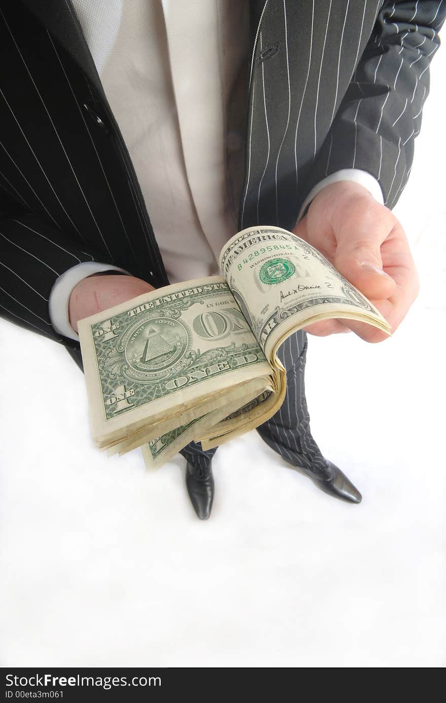 Businessman in  black suit counts dollar denominations on  white background. Businessman in  black suit counts dollar denominations on  white background