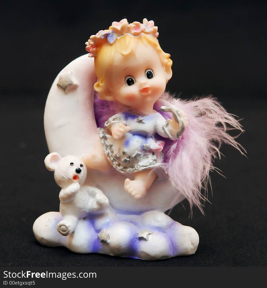 Small toy angel as a souvenir for an ornament. Small toy angel as a souvenir for an ornament