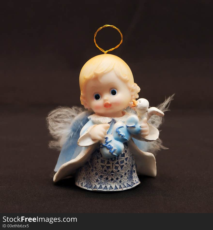 Small toy angel as a souvenir for an ornament. Small toy angel as a souvenir for an ornament