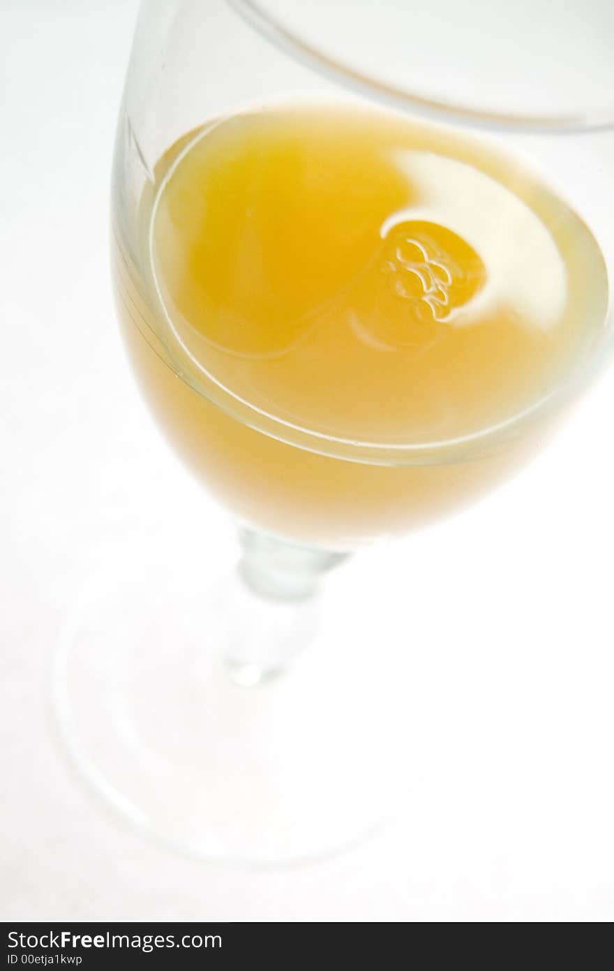 Wineglass with orange juice, liquid, closeup. Wineglass with orange juice, liquid, closeup