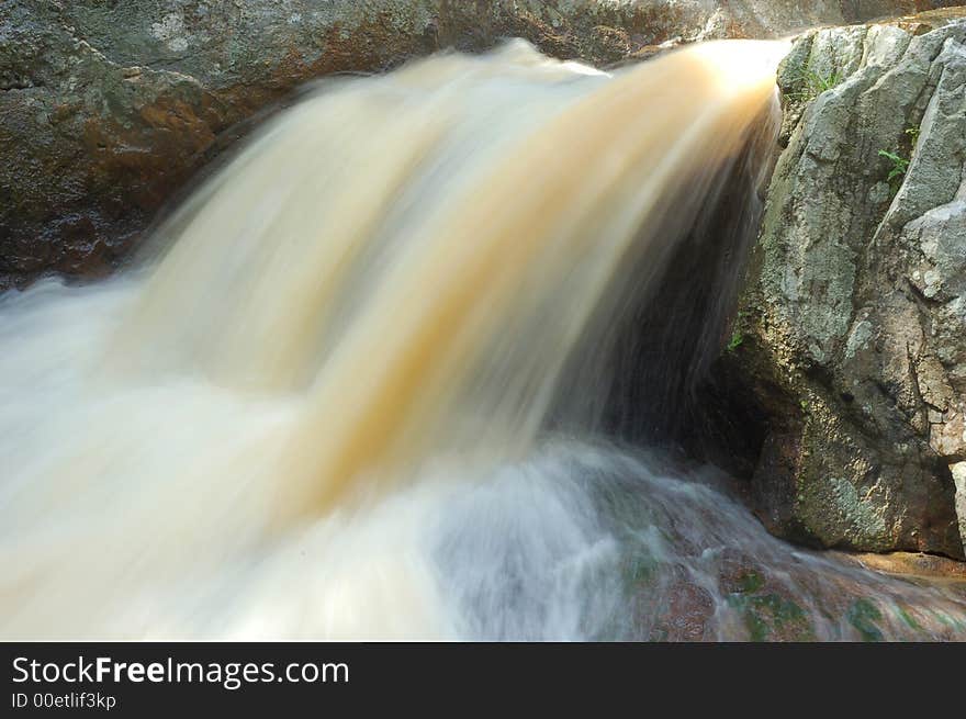 Beautiful small waterfall amongst stone