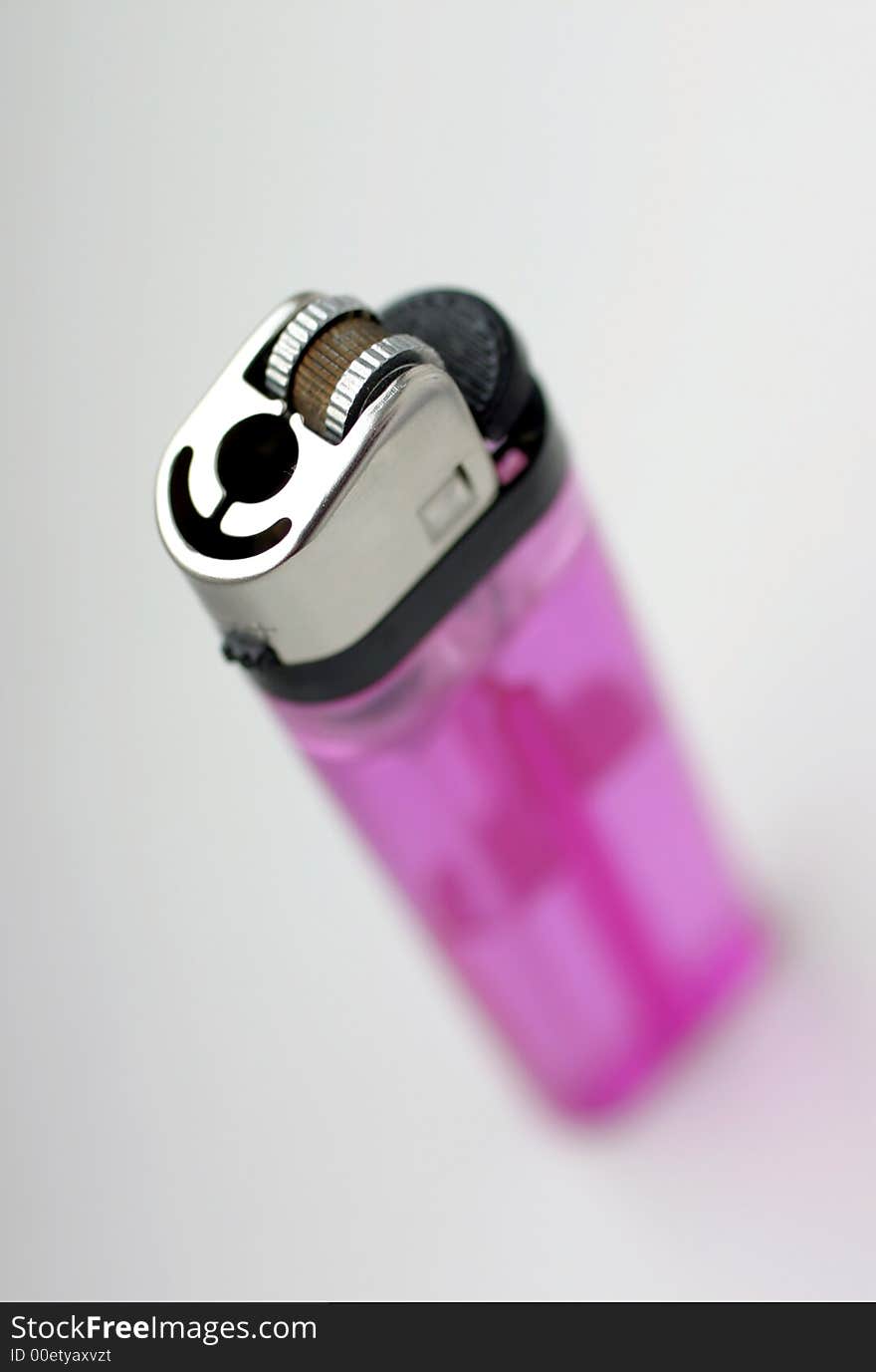 Pink cigarette lighter, extreme close-up, focus on ignition part