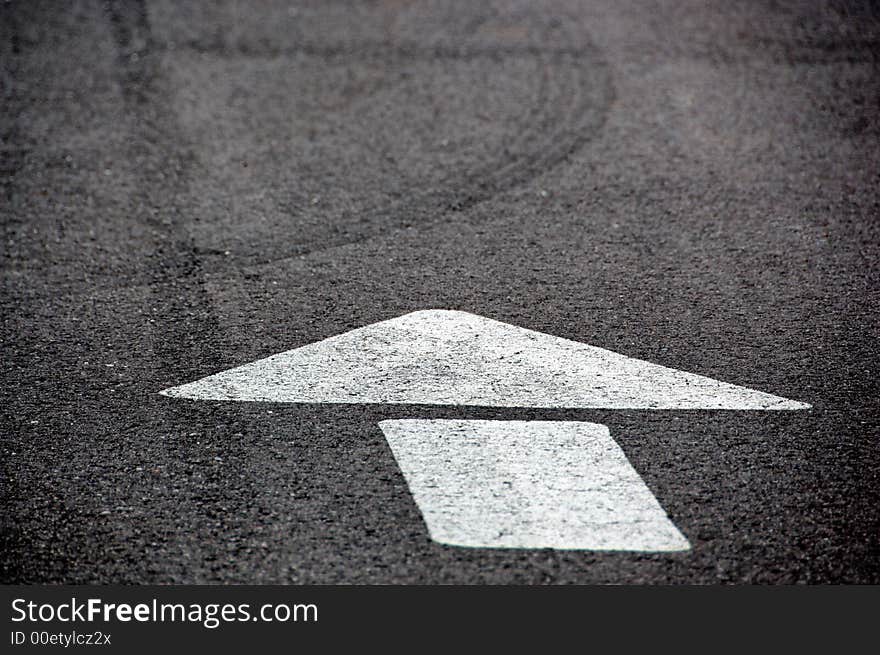 Directional arrown on black asphalt road. Directional arrown on black asphalt road