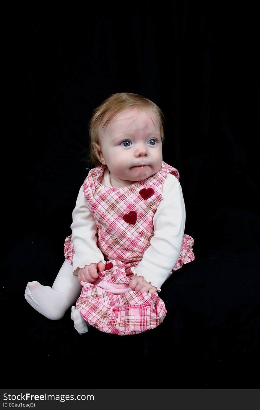 Cute little girl on black background