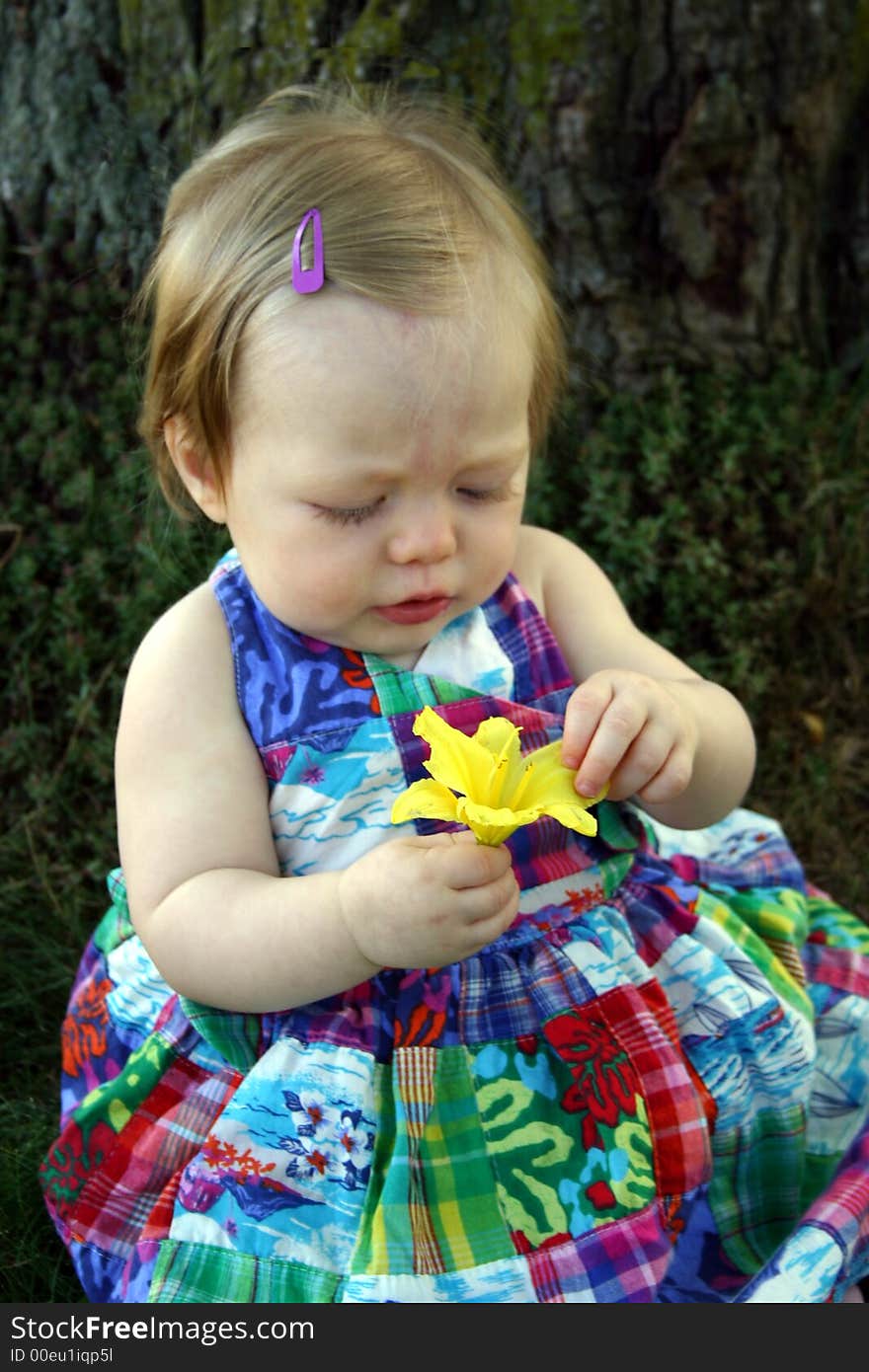 Cute little girl sitting outside with flower. Cute little girl sitting outside with flower