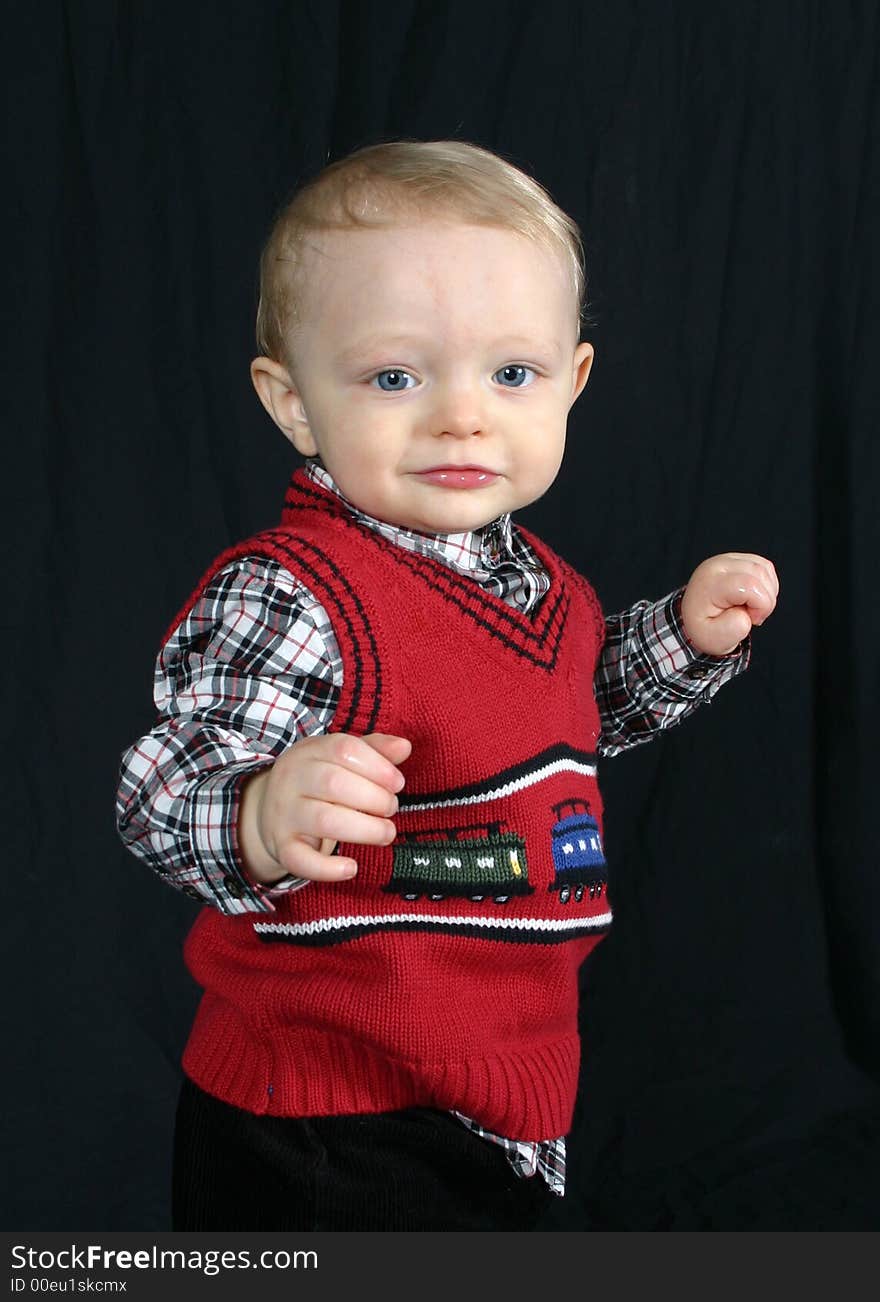 Cute little boy on black background