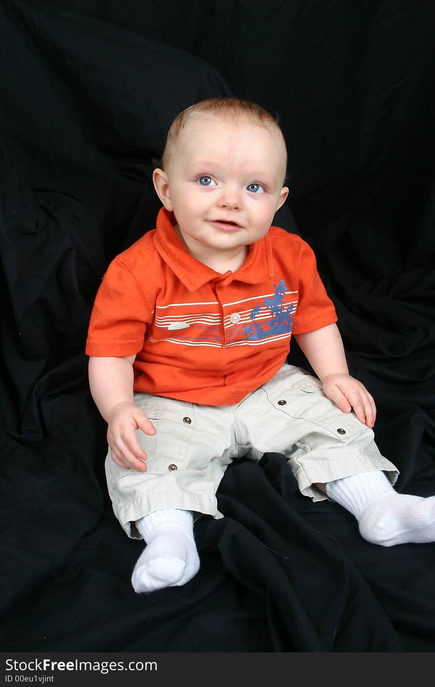 Cute little boy on black background