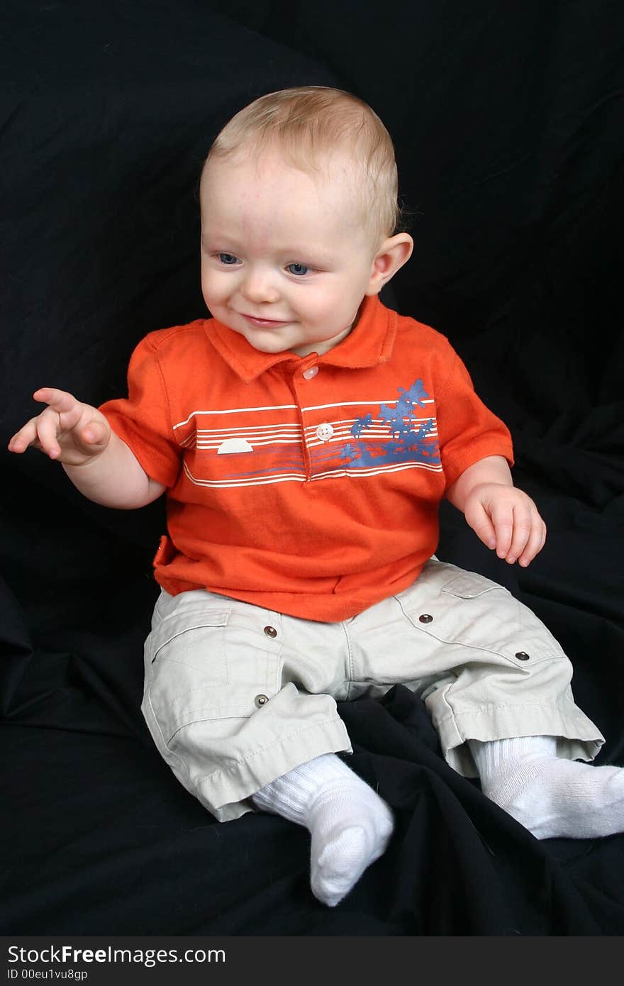 Cute little boy on black background