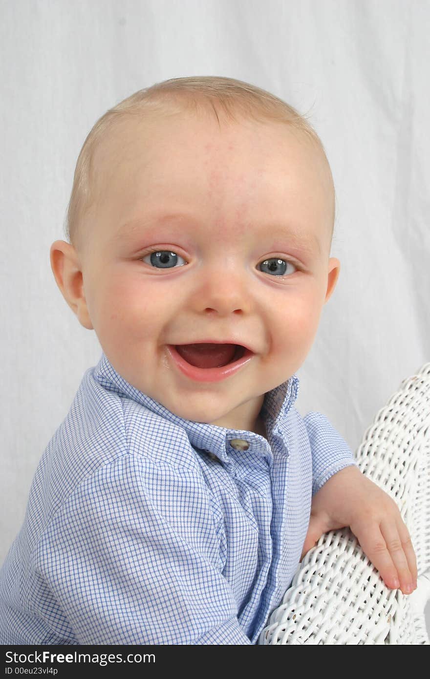 Cute little boy smiling on a white background