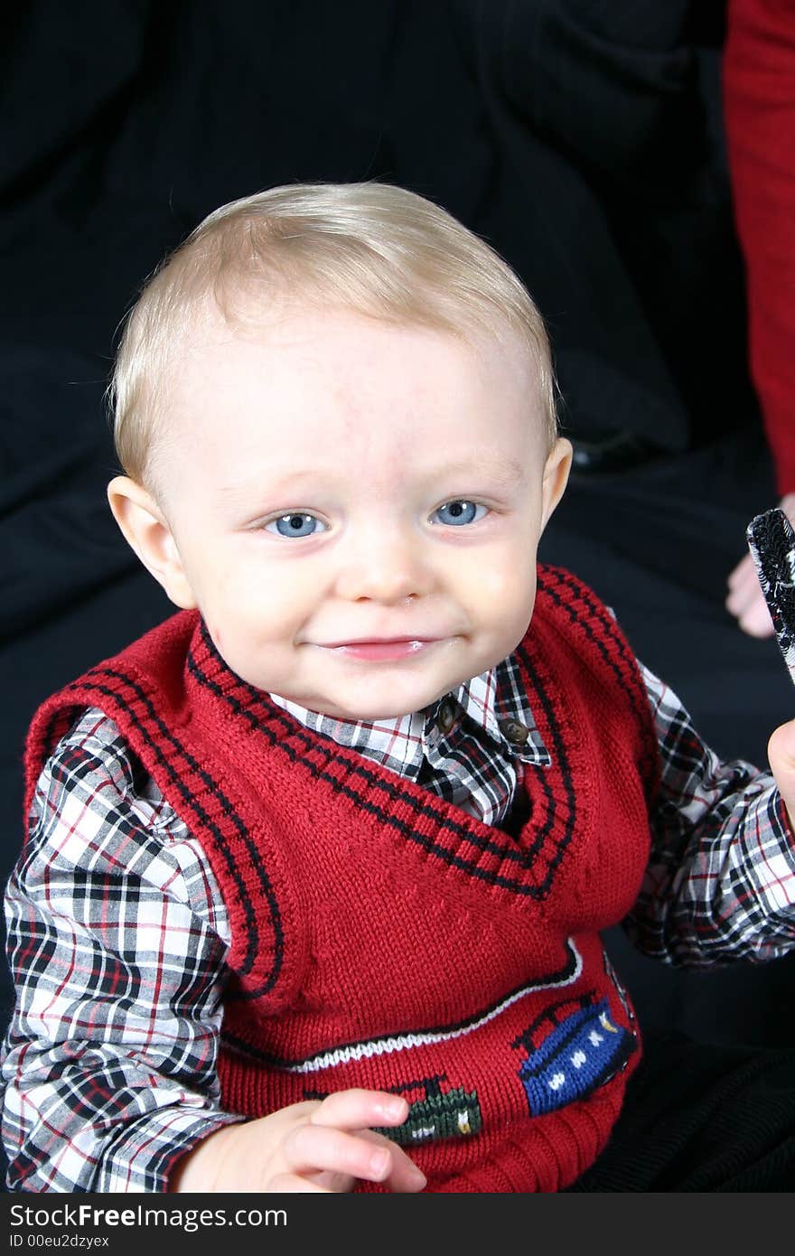 Cute little boy smiling on a black background